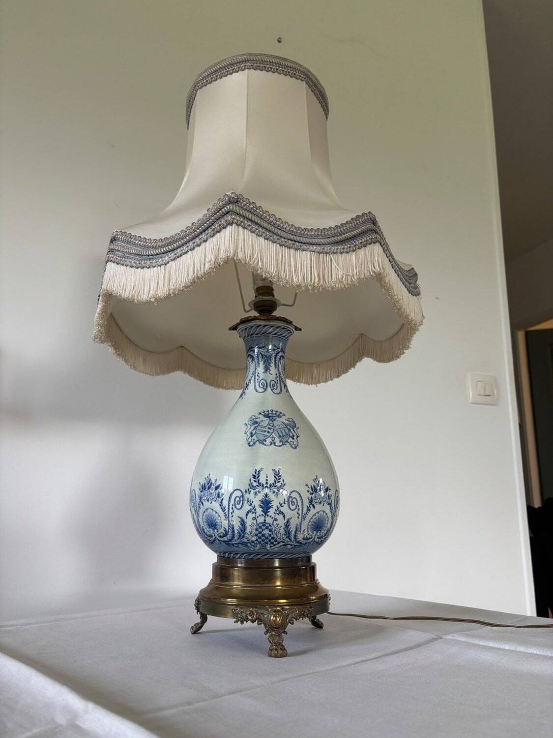 19th-century blue grand feu faience lamp, tripod bronze, fringed lampshade.