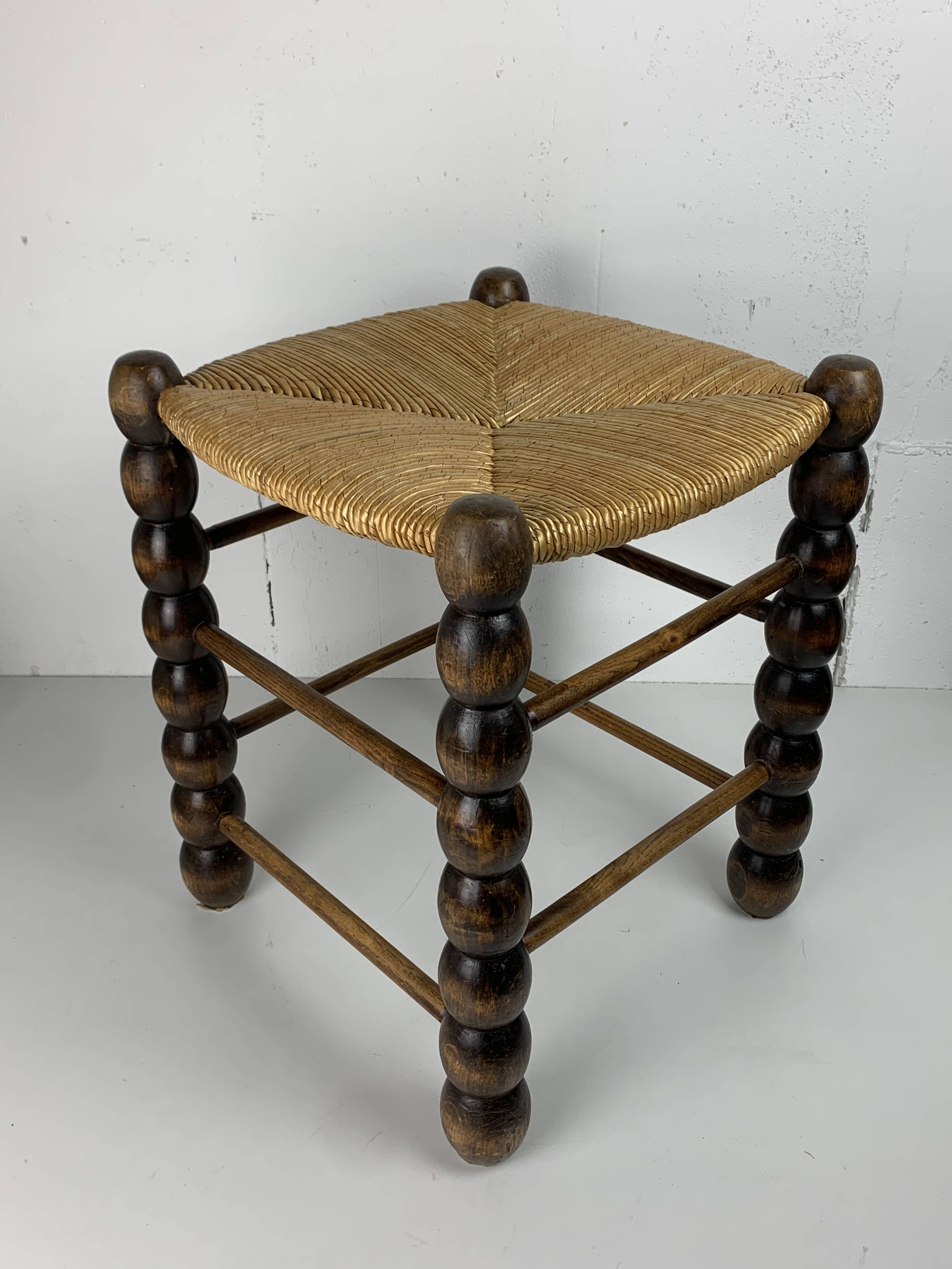 Brutalist wood turned bobbin rush stool in the style of Charles Dudouyt