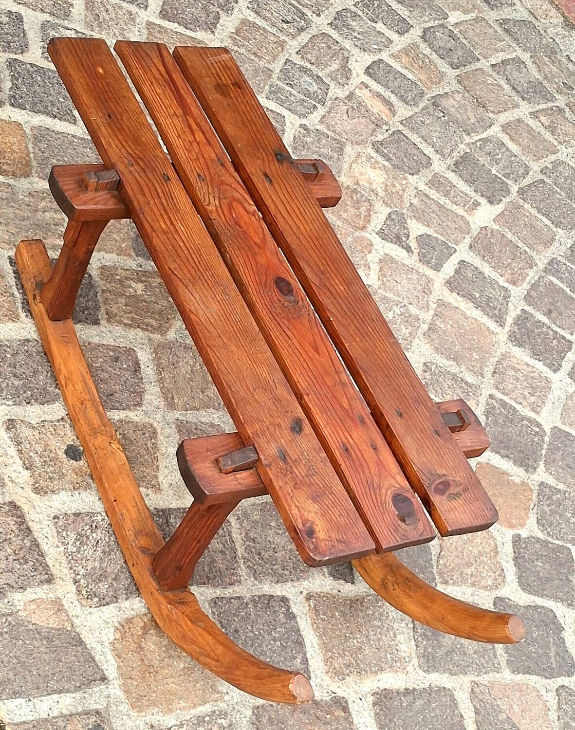 Rustic bench, old folk art, snow sled, Alps.