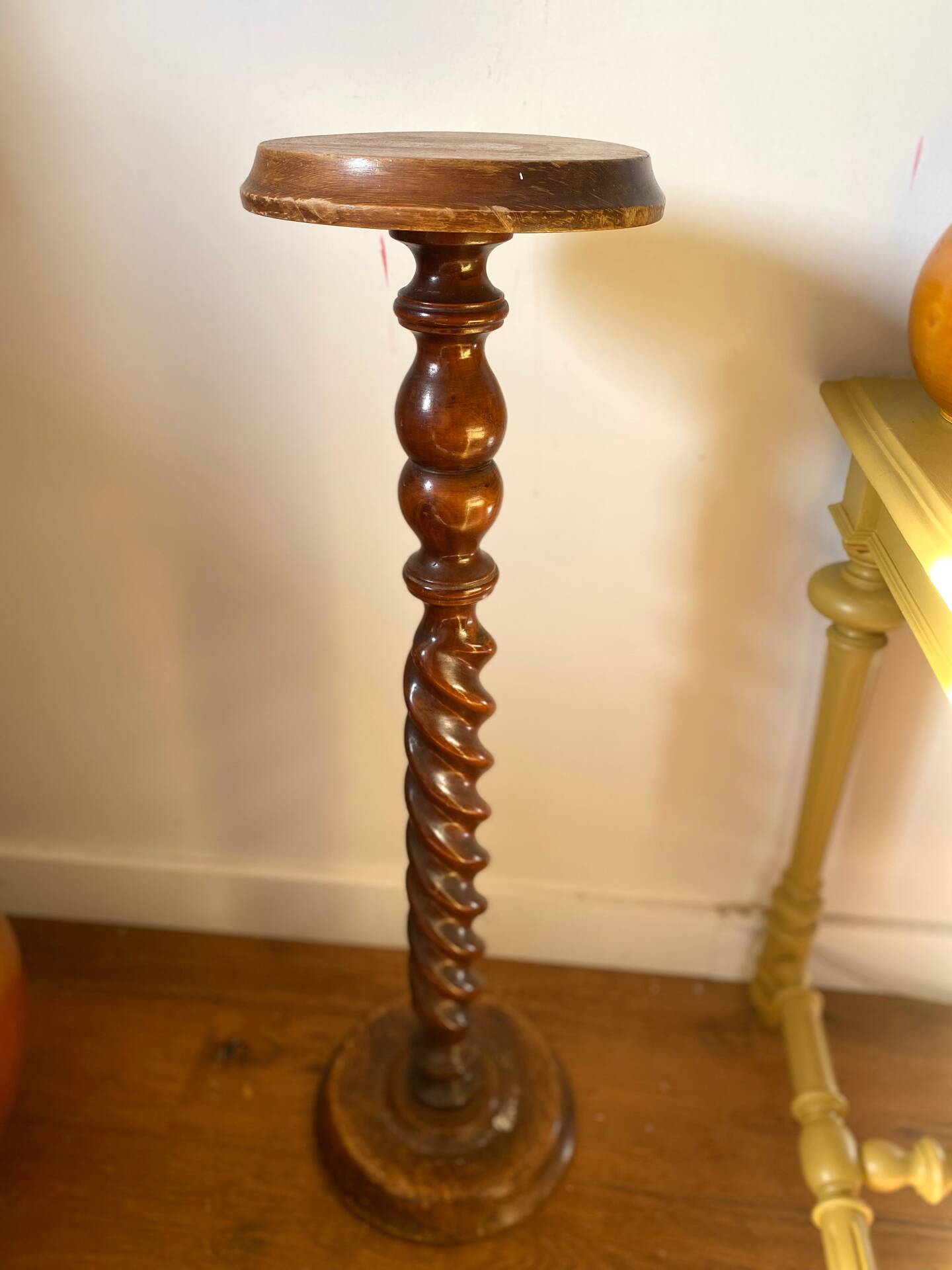 Antique pedestal table with a twisted column.