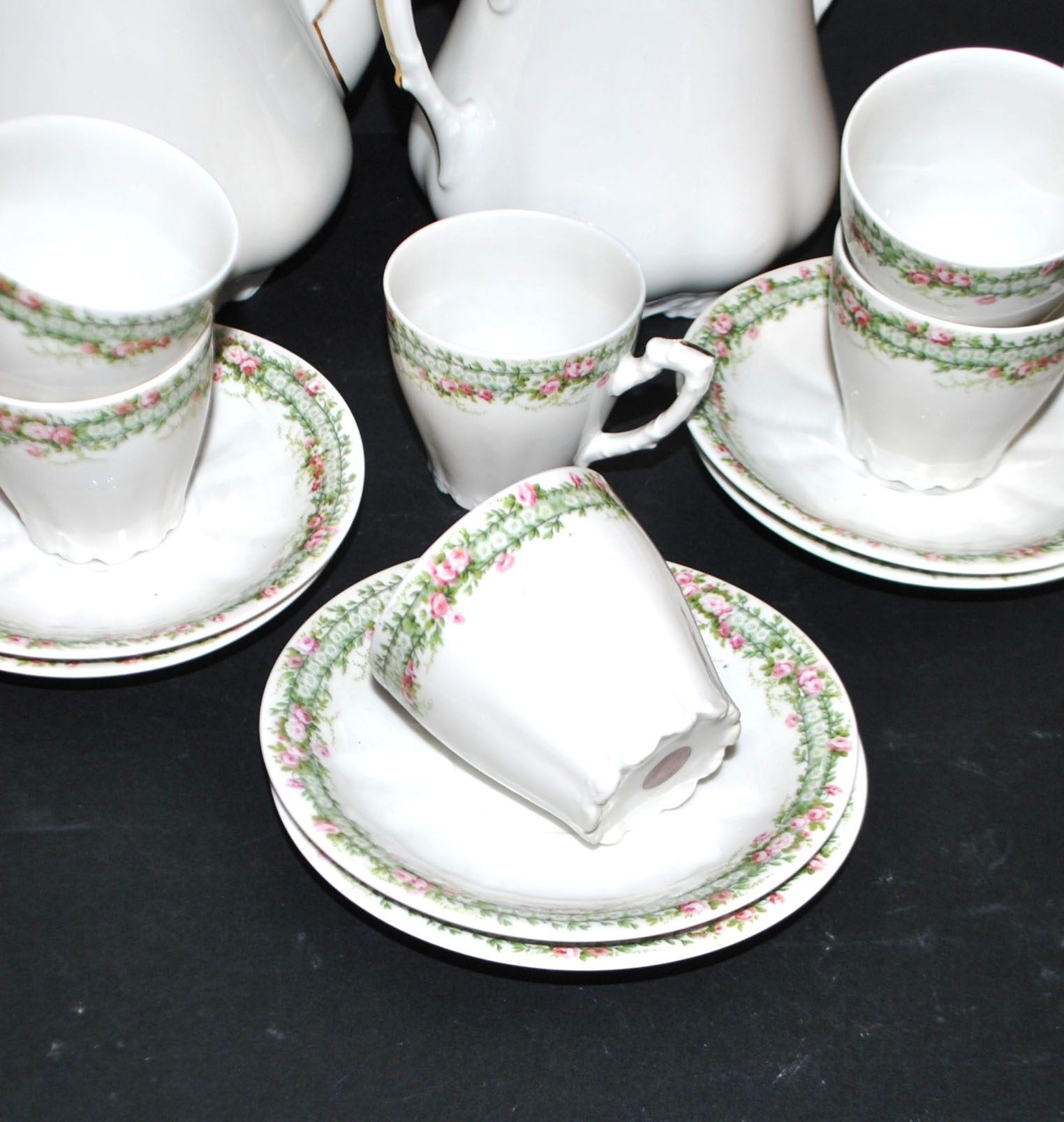 Vintage Limoges coffee service with pink and green floral decoration, coffee pot, sugar bowl, and 6 cups.