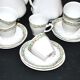 Vintage Limoges coffee service with pink and green floral decoration, coffee pot, sugar bowl, and 6 cups.