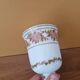 Footed glass in the shape of a chalice in white opaline with a floral decoration.