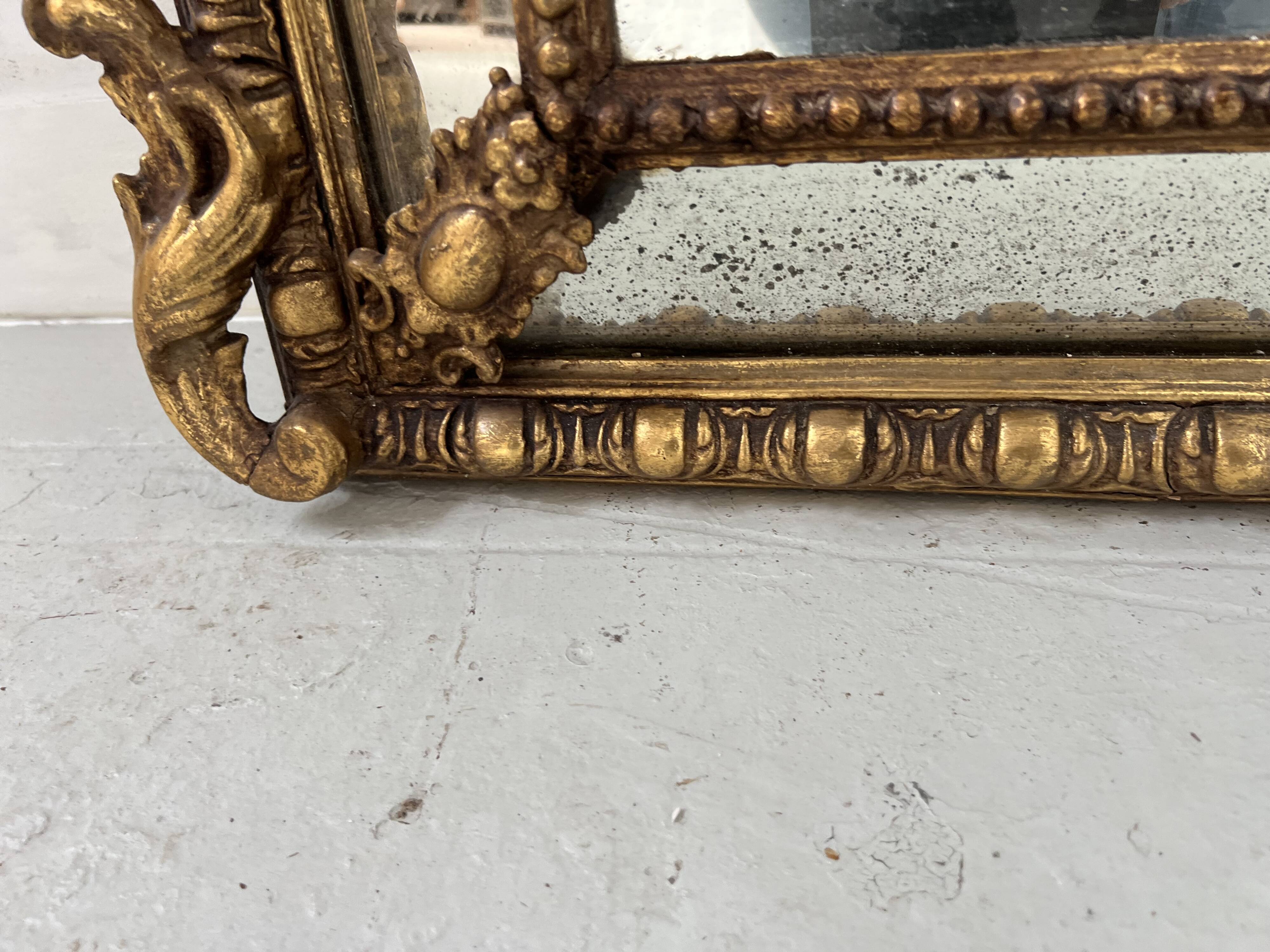 Louis XVI style mirror with parecloses in wood and gilded stucco, 19th century