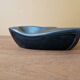 Ceramic ashtray with green and black glaze forming a pipe holder