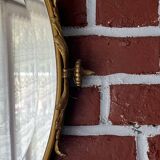 Beveled oval mirror in gilded bronze