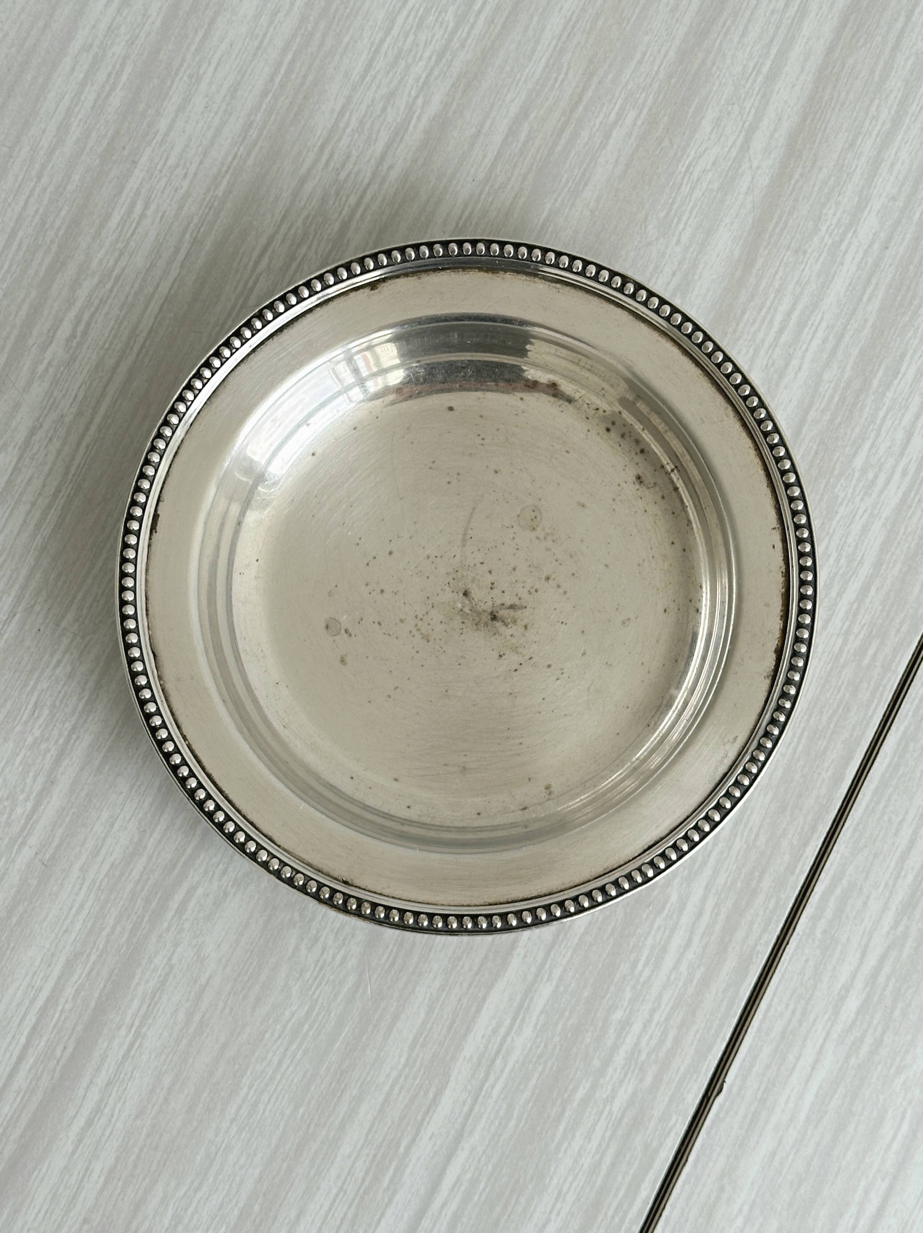 Round patinated silver-plated metal dish