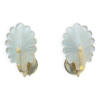 Pair of wall lights with frosted glass and brass shell design.