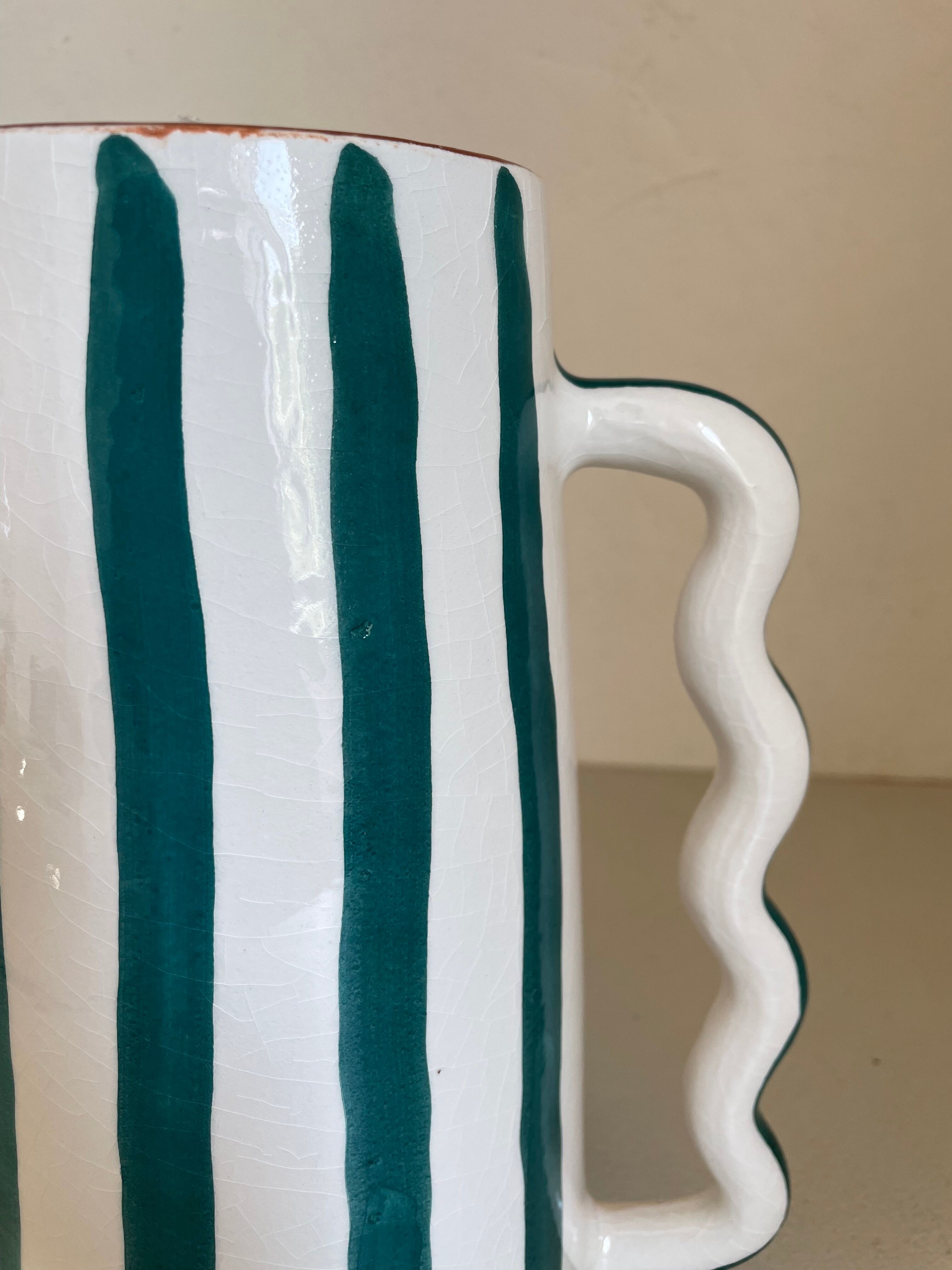 Fir and white green striped ceramic vase with handmade abstract wavy handles