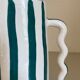 Fir and white green striped ceramic vase with handmade abstract wavy handles