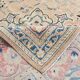 Antique Turkish wool rug in faded floral patterns, 10 x 13 feet.