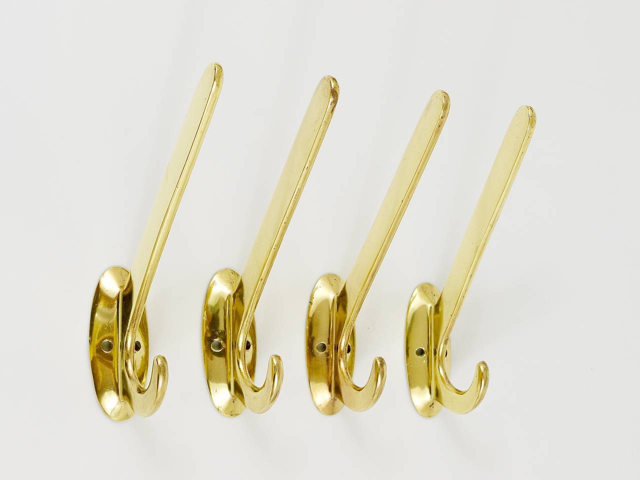 Four handmade brass wall hooks in Art Nouveau style, Austria, 1920s.