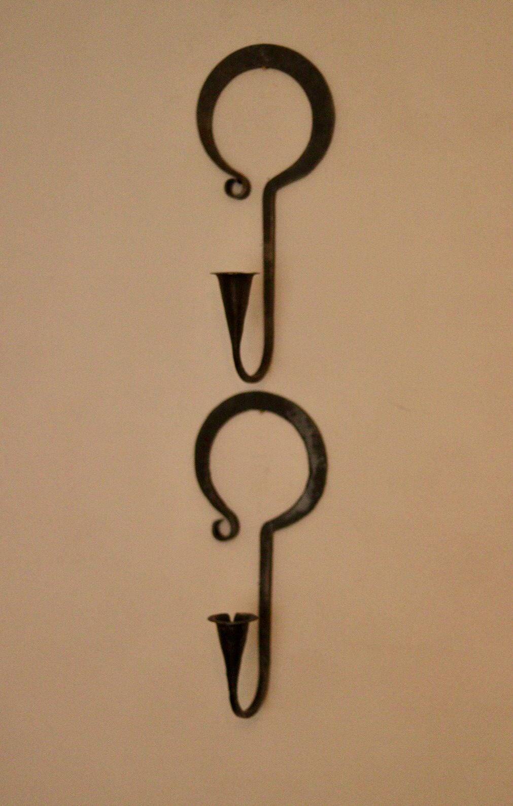 Pair of Swedish wall sconces in wrought iron, mid-20th century style, signed Akta.