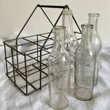 4 graduated bottles in their bottle holder