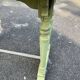 Old table with patinated green legs