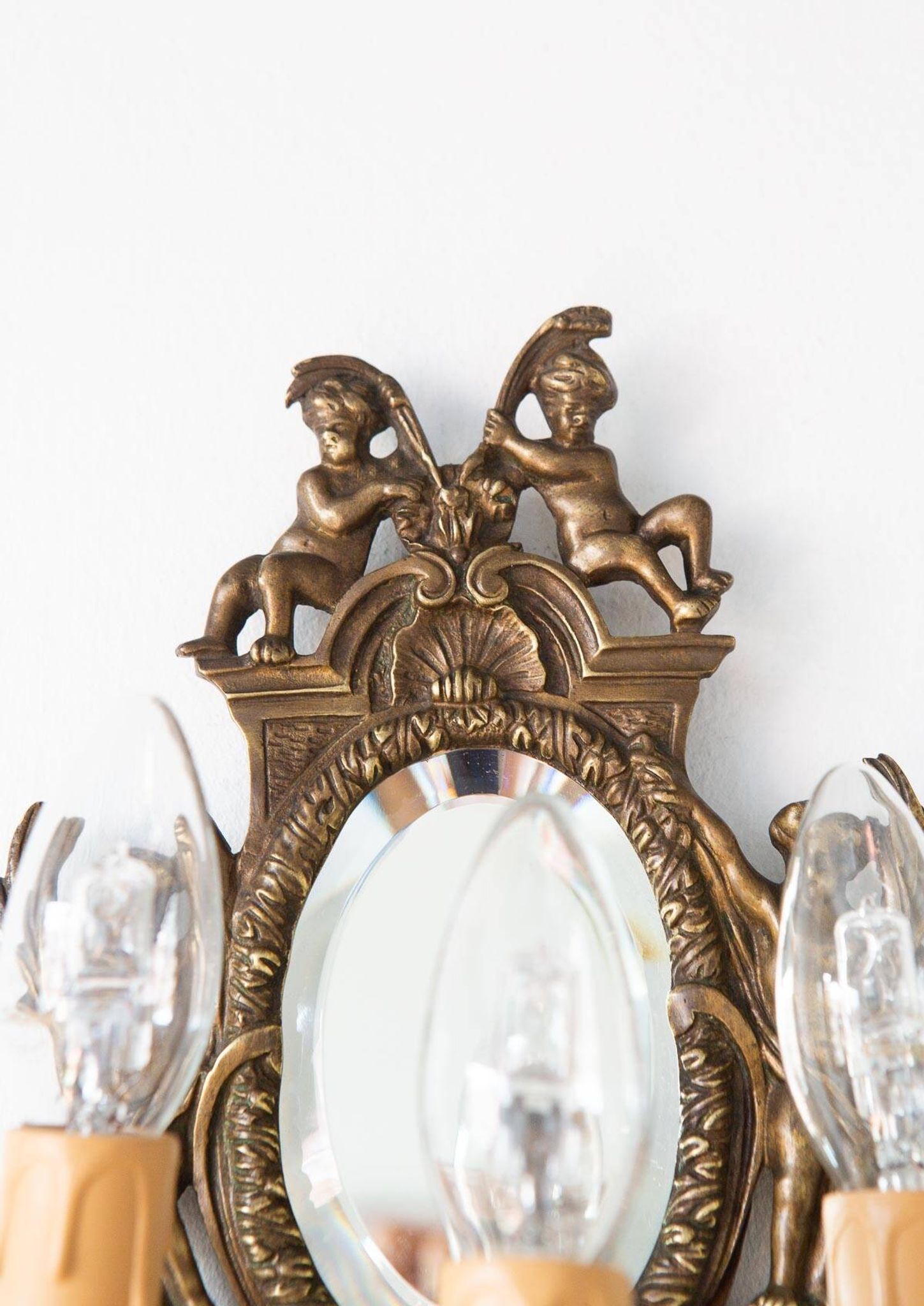 Pair of old French wall lights with beveled mirror and putti
