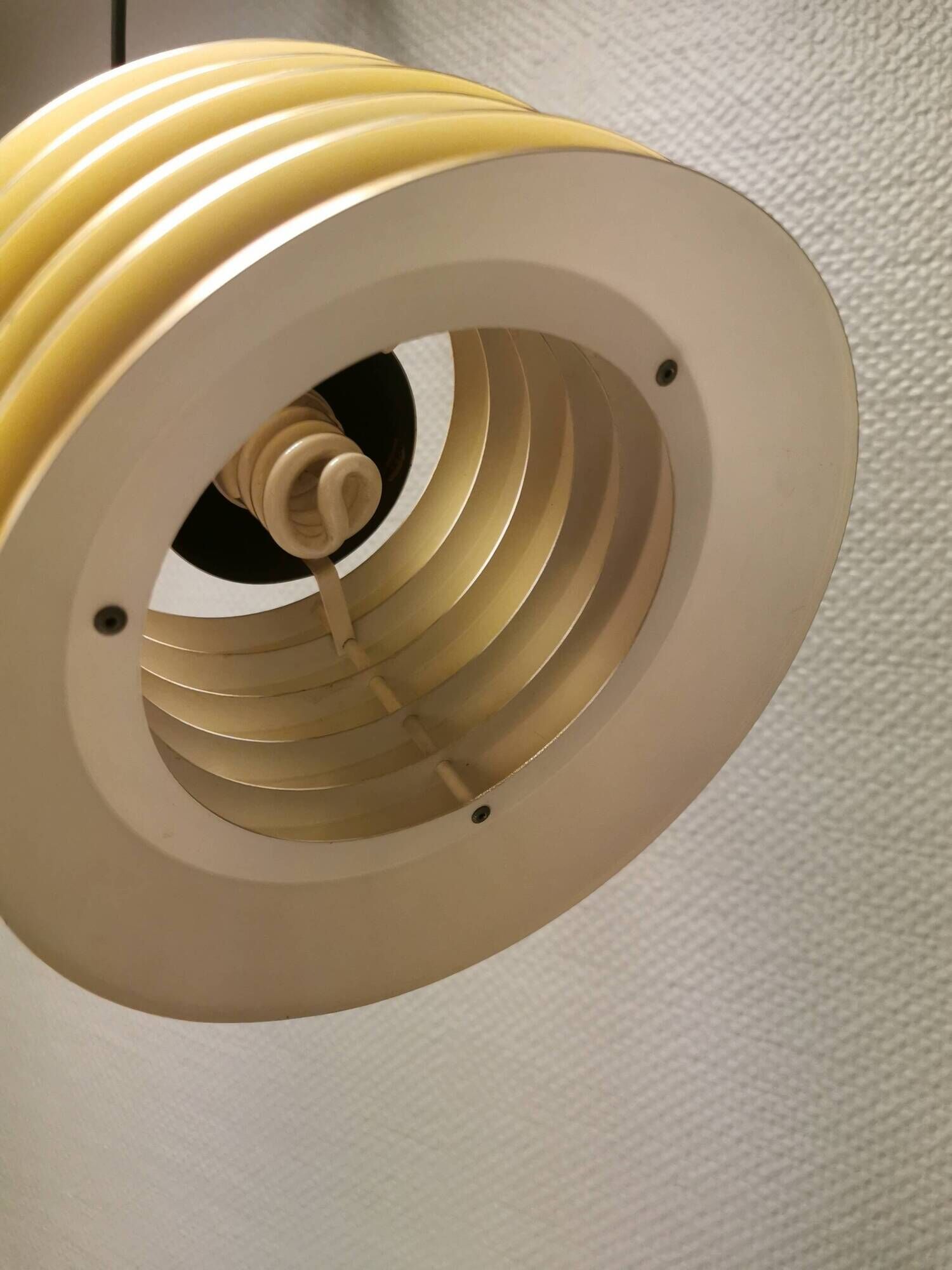 Hanging lamp in gold-colored aluminum with many layers of shades.