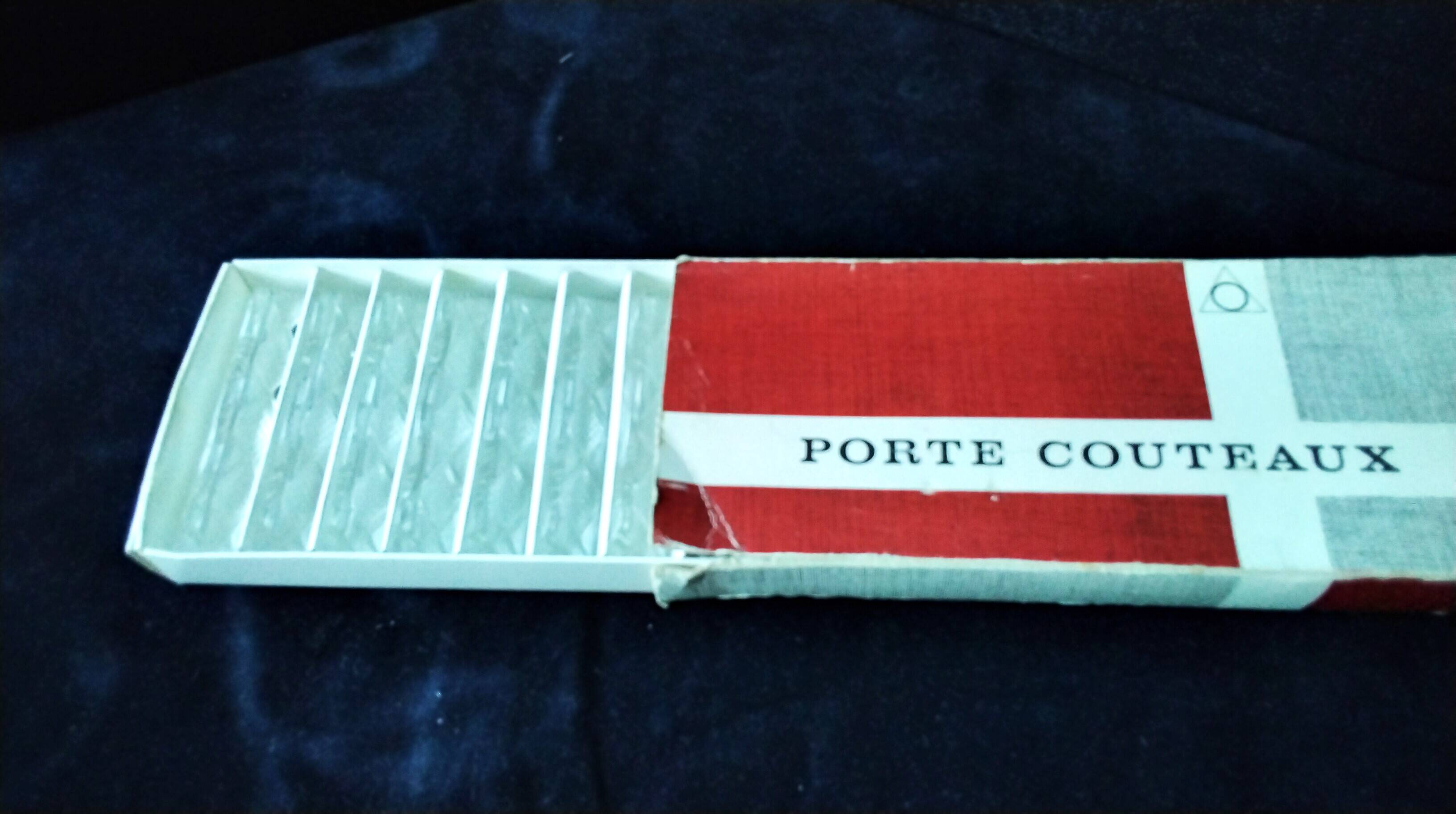 Set of 12 lead crystal knife rests in a triangular shape.