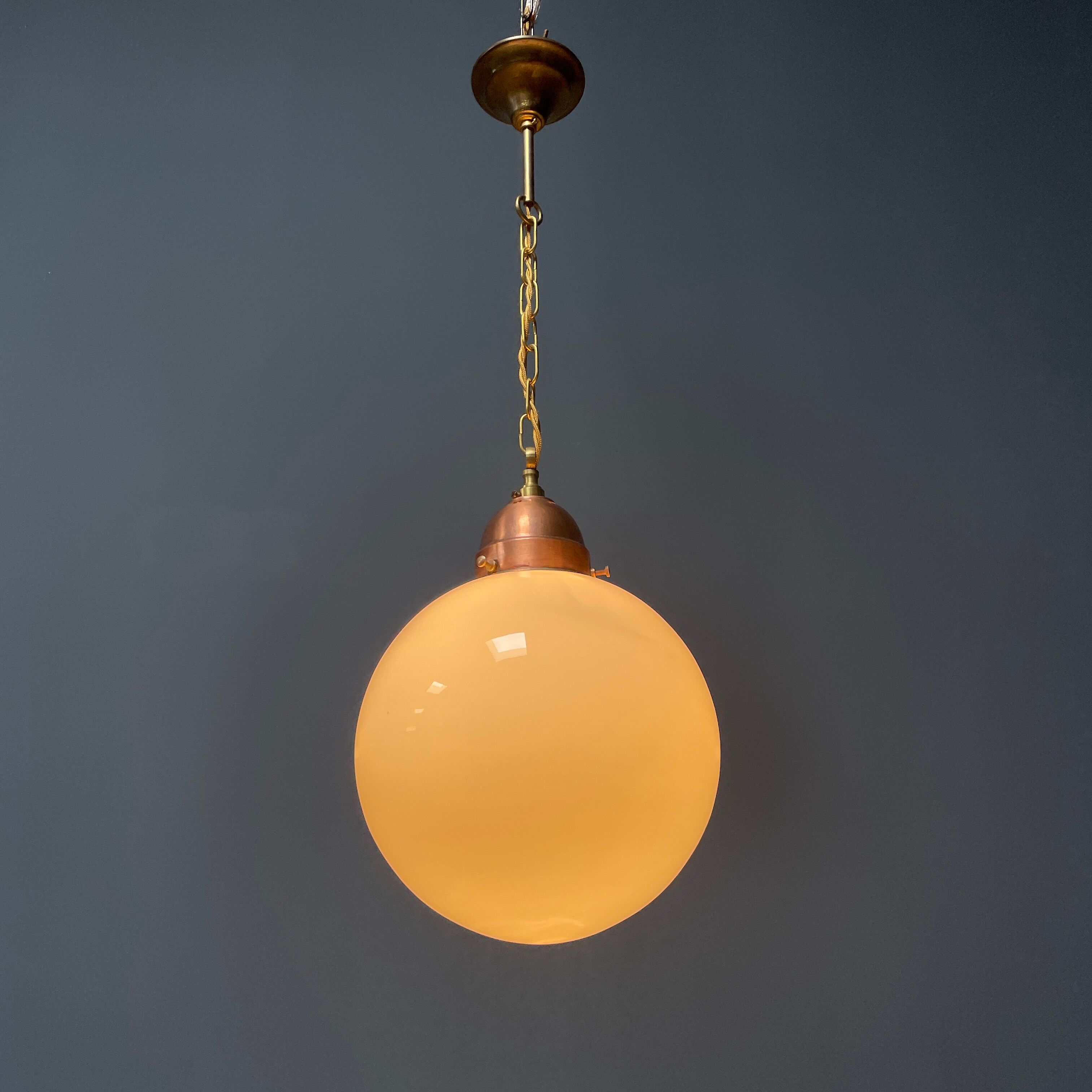 Opaline glass ball hanging lamp with copper fixture