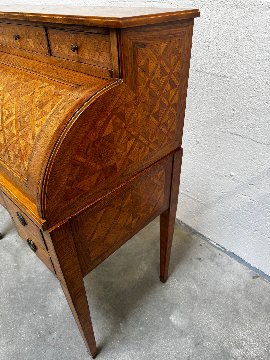 Cylinder desk with marquetry featuring a crosshatch design.