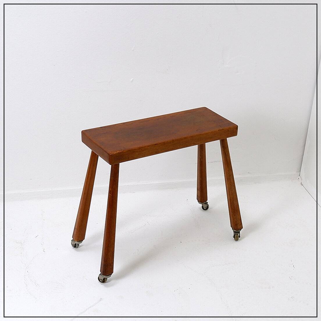 Vintage solid wood side table on casters