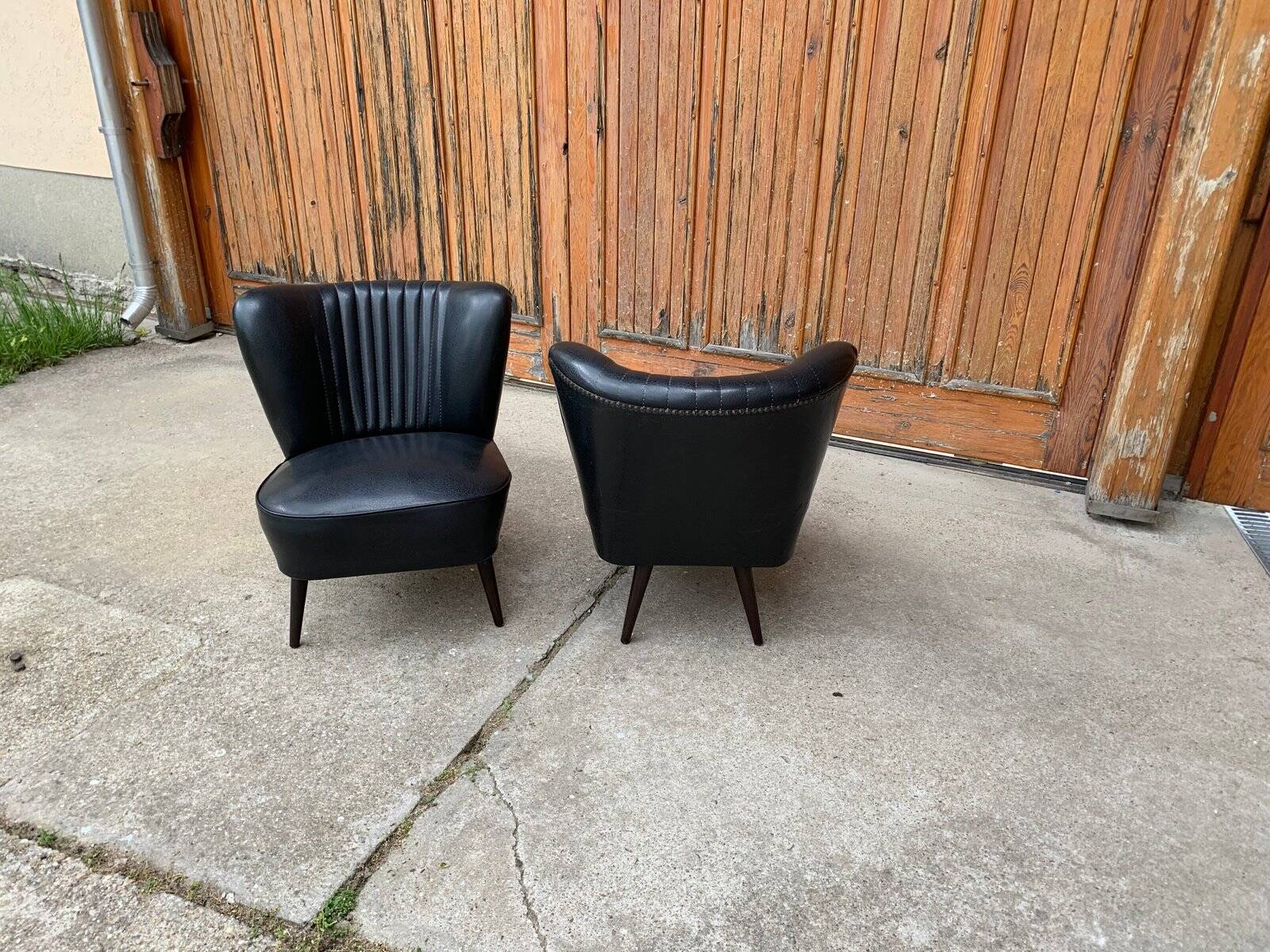 Pair of black cocktail chairs in beech and vinyl, Mid-Century style, 1950s.