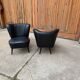 Pair of black cocktail chairs in beech and vinyl, Mid-Century style, 1950s.