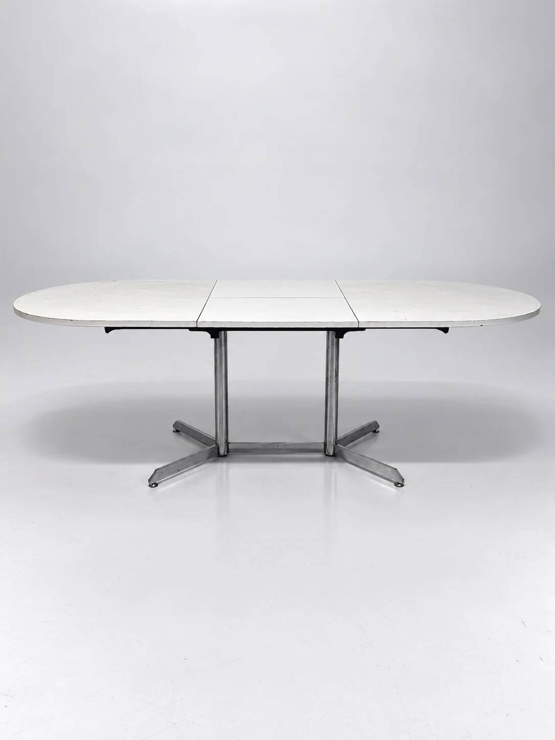 Vintage oval extendable dining table, white laminate and chrome, 1970s.