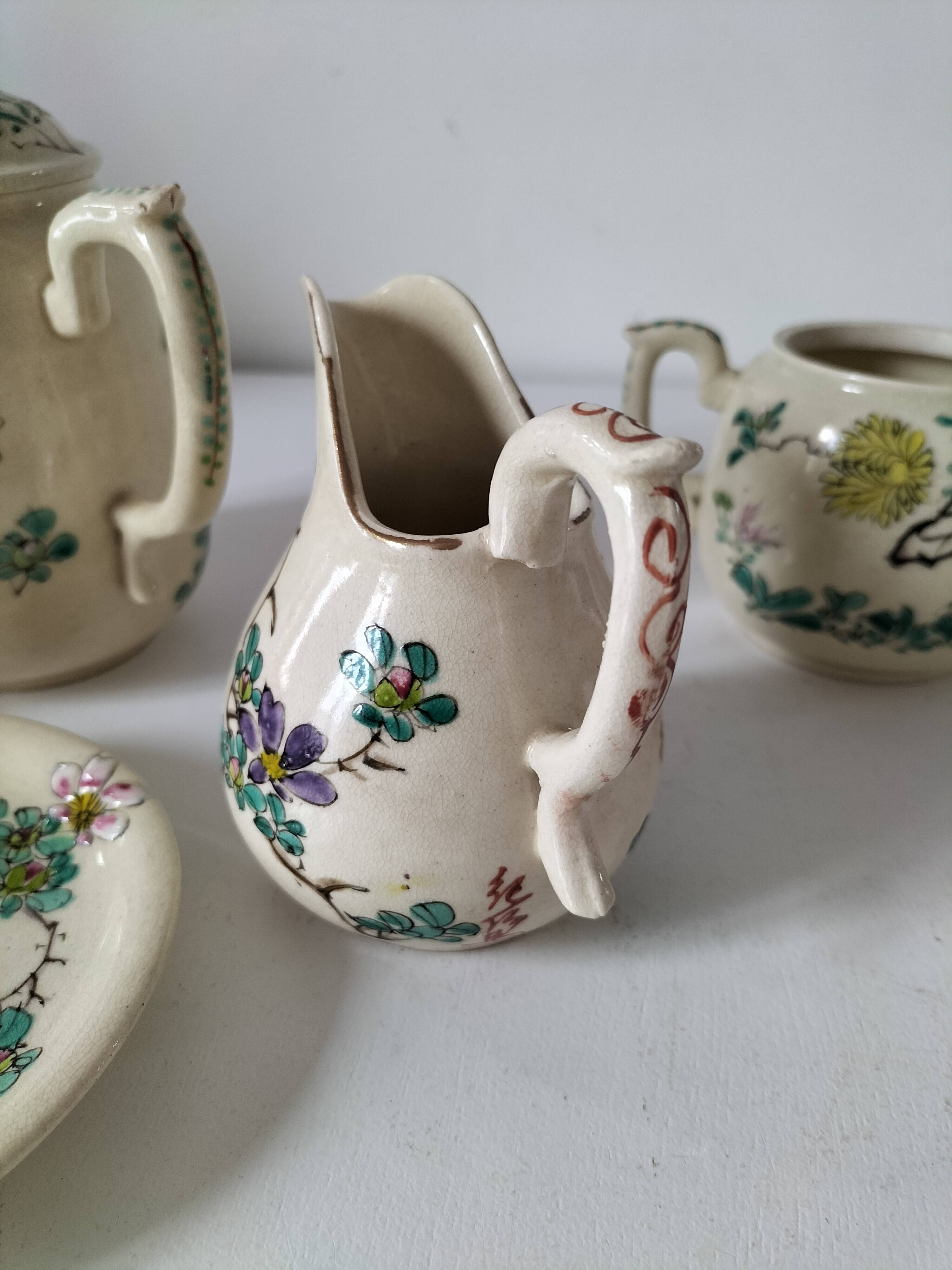 Japanese-style tea set in cracked earthenware with chrysanthemum flowers