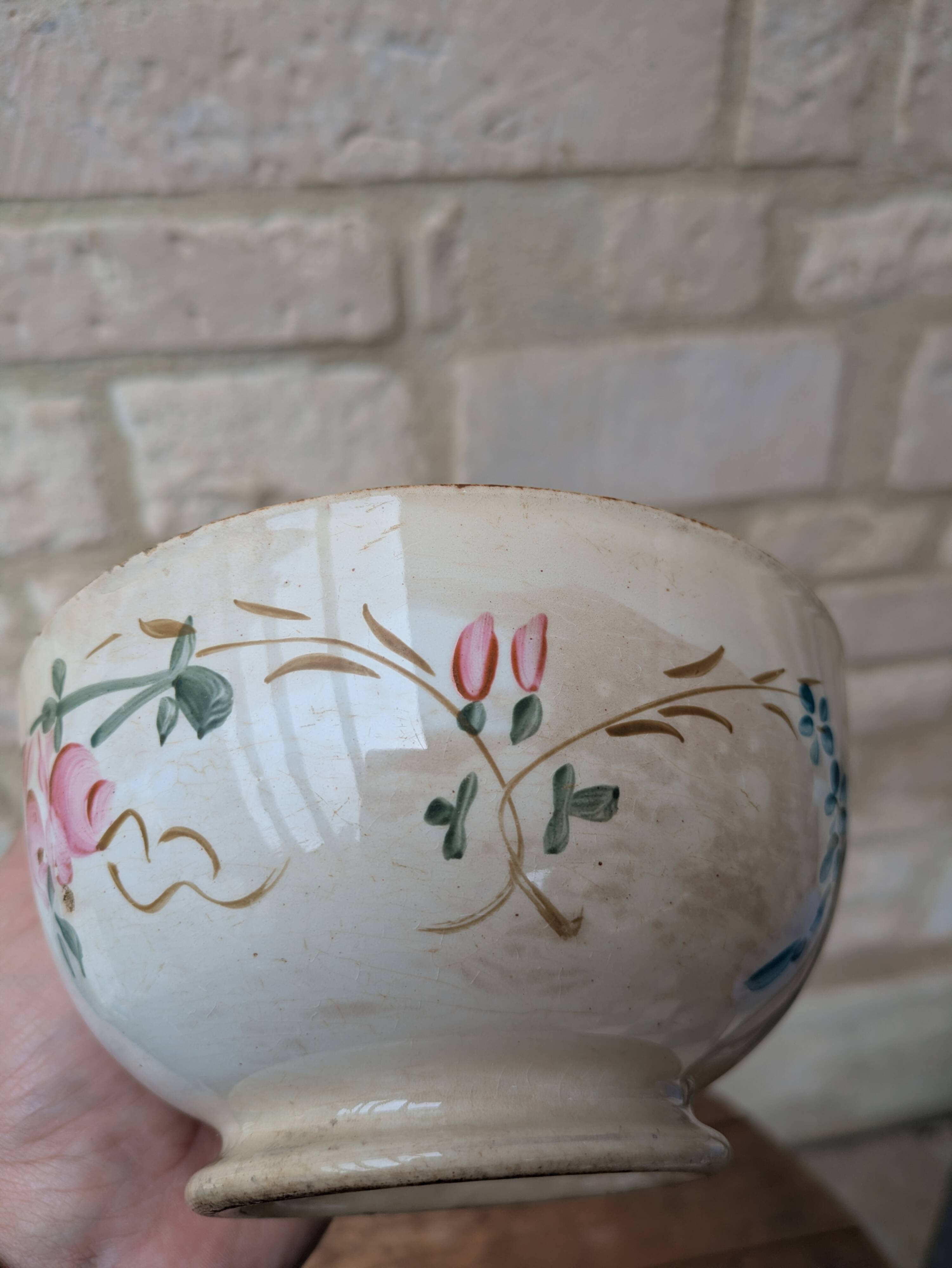 Old opaque porcelain bowl from Gien with a floral decoration.