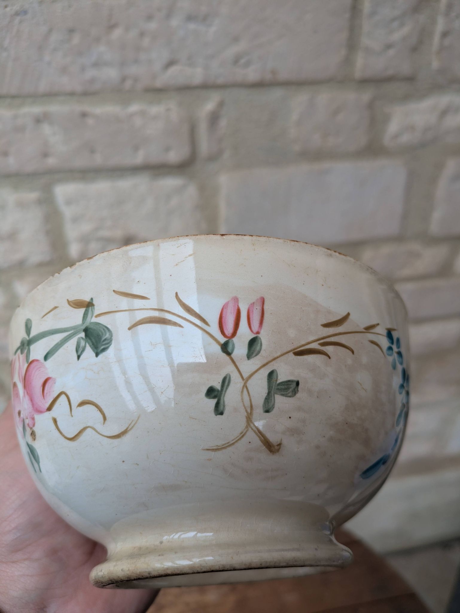 Old opaque porcelain bowl from Gien with a floral decoration.