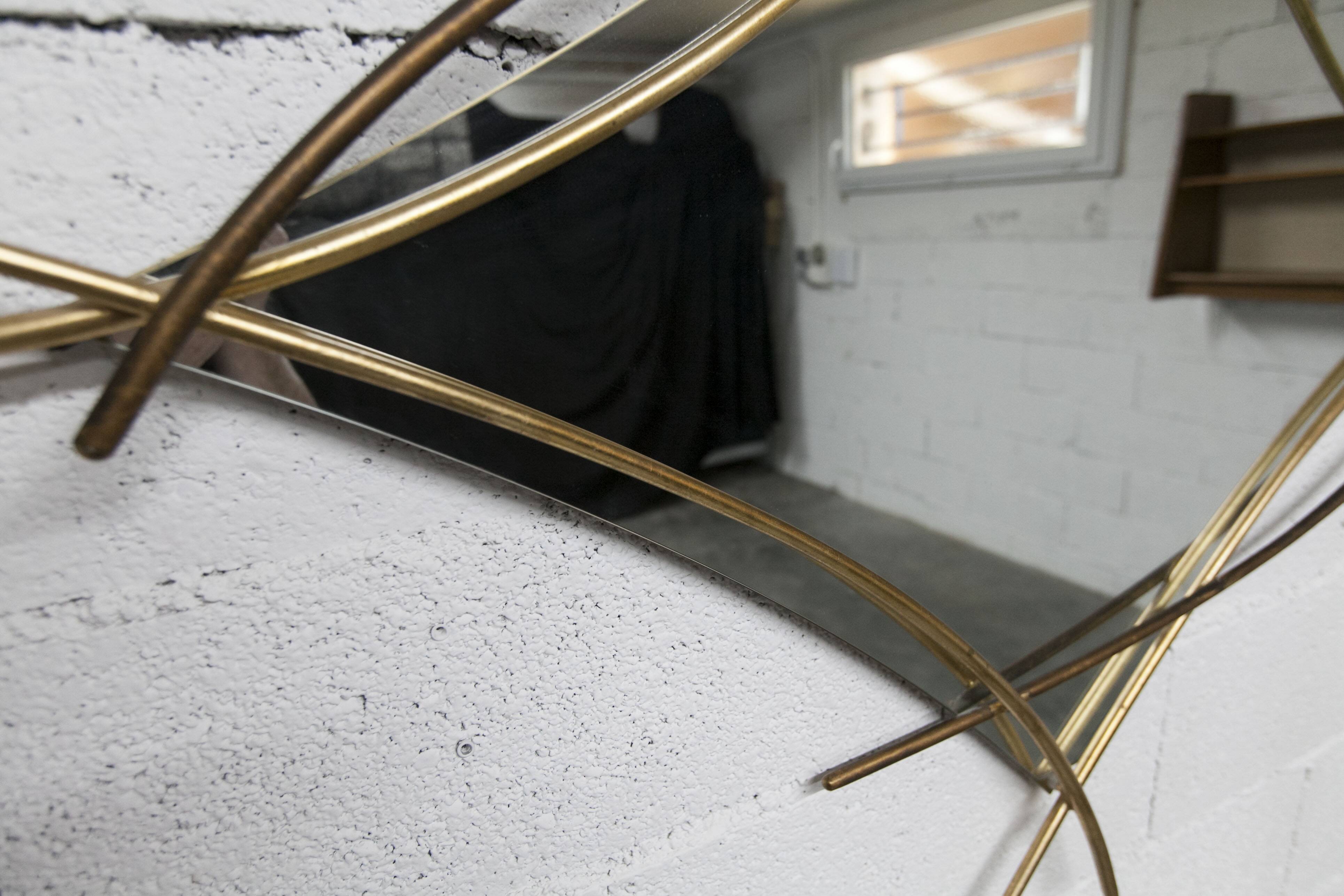 Sculptural mirror with two-tone gilded arches, France, 1970s, 95 x 133 cm