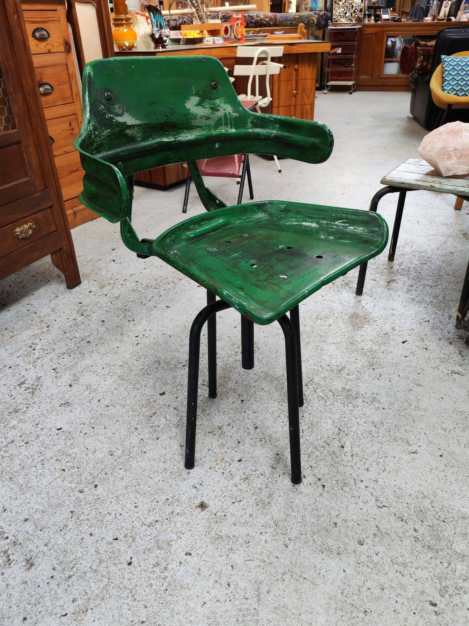 Vintage swivel workshop chair in green pressed sheet metal with a folding backrest.