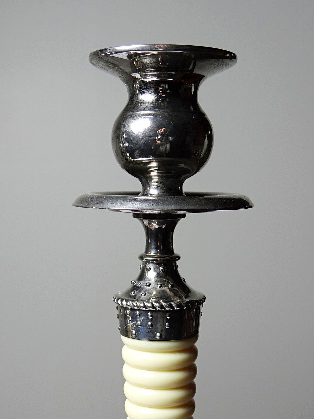 Pair of vintage candlestick holders in silver-plated metal with ivory-style plastic.