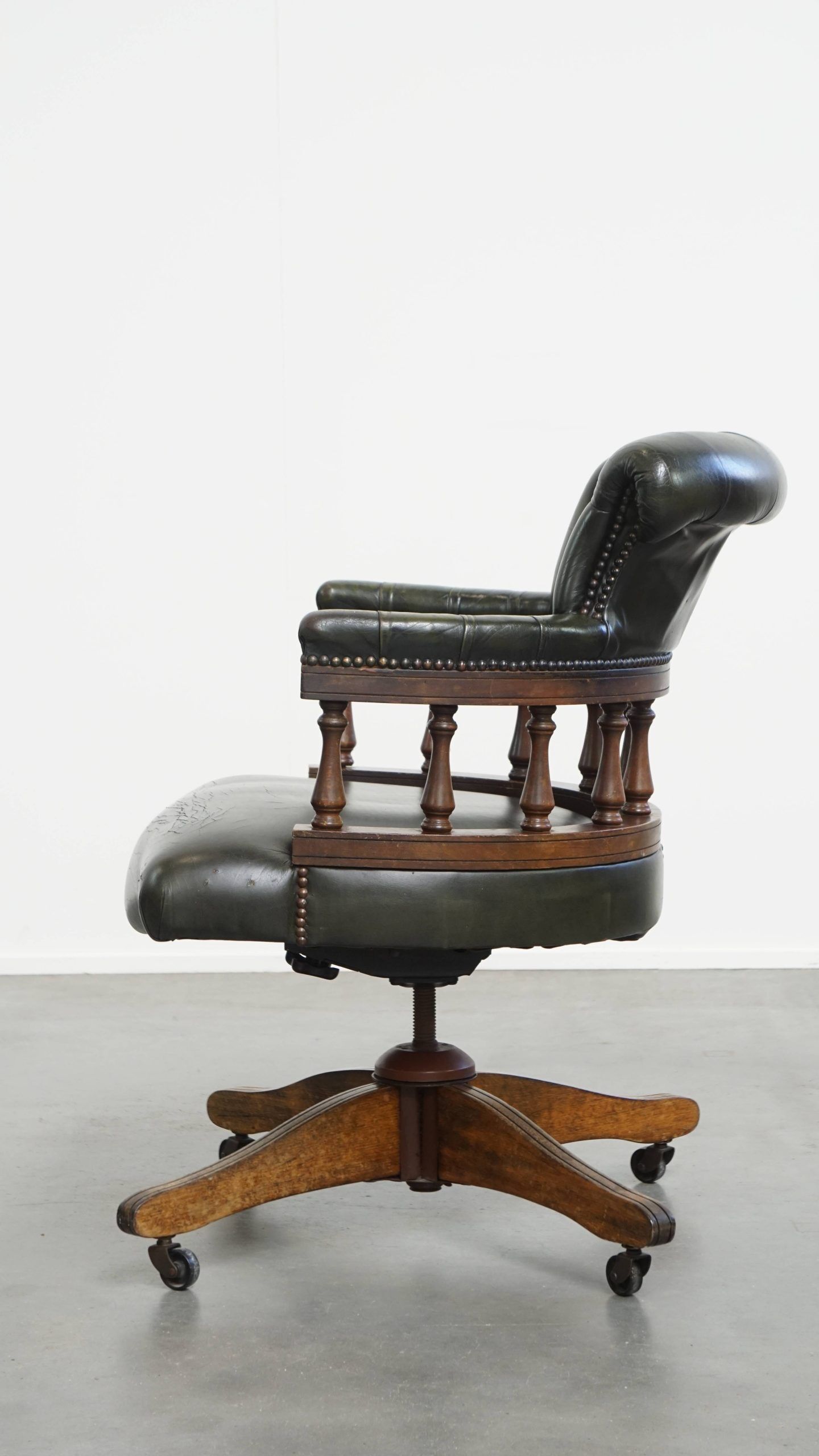 Adjustable green leather and wood Chesterfield office chair with swivel