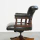 Adjustable green leather and wood Chesterfield office chair with swivel