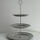 Three-tiered serving trolley in shiny stainless steel.