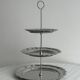 Three-tiered serving trolley in shiny stainless steel.
