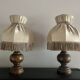 Pair of wooden bedside lamps with vintage fringe lampshades.
