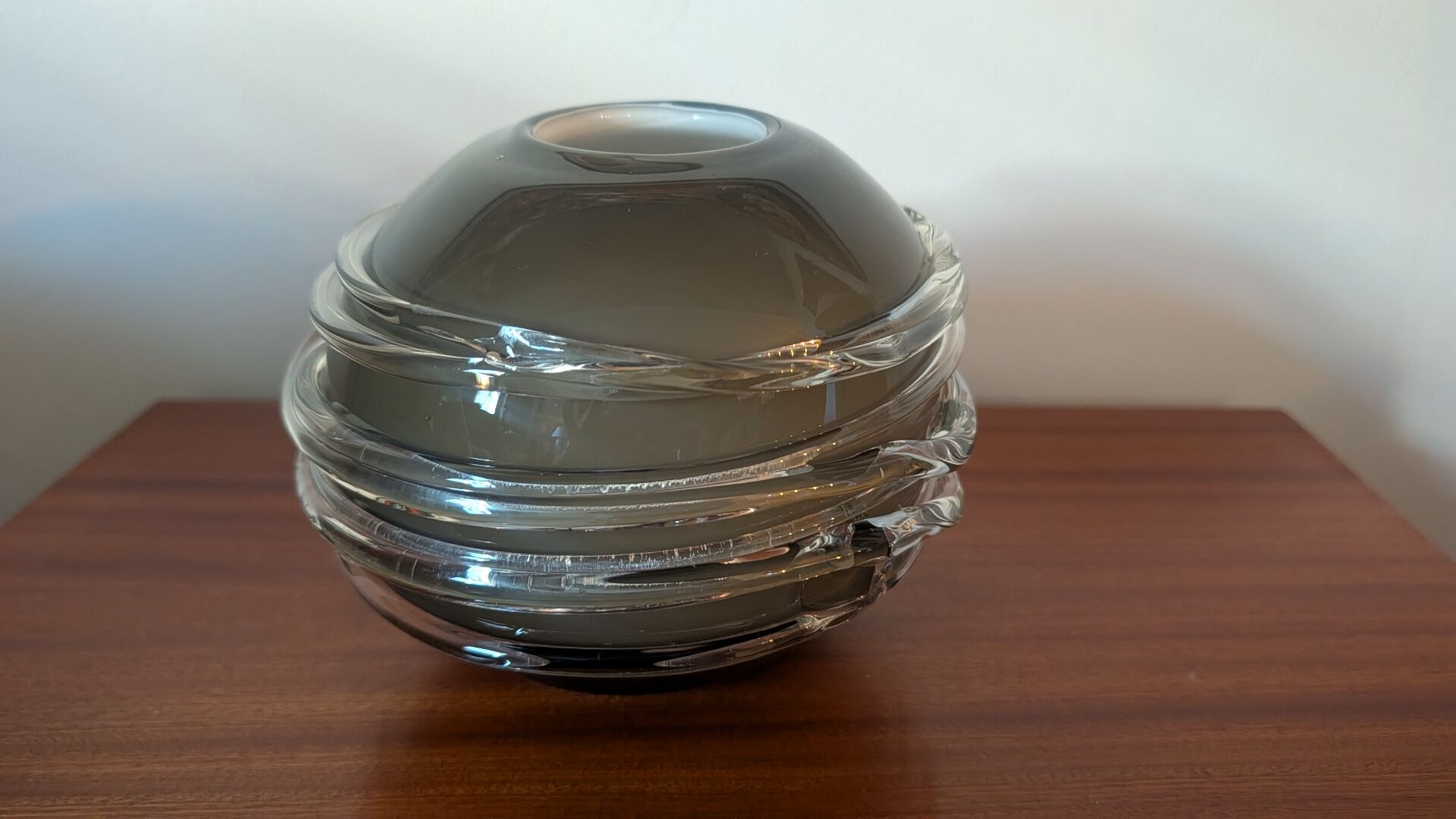 Smoky glass spherical vase with spiral applications from the 1970s.