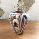 Vase dripping in varnished earth