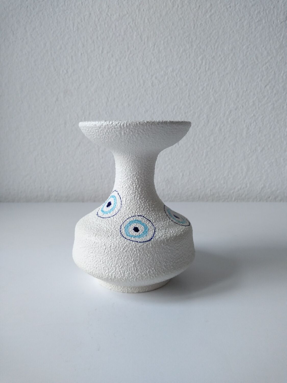 White and blue ceramic vase with italian relief