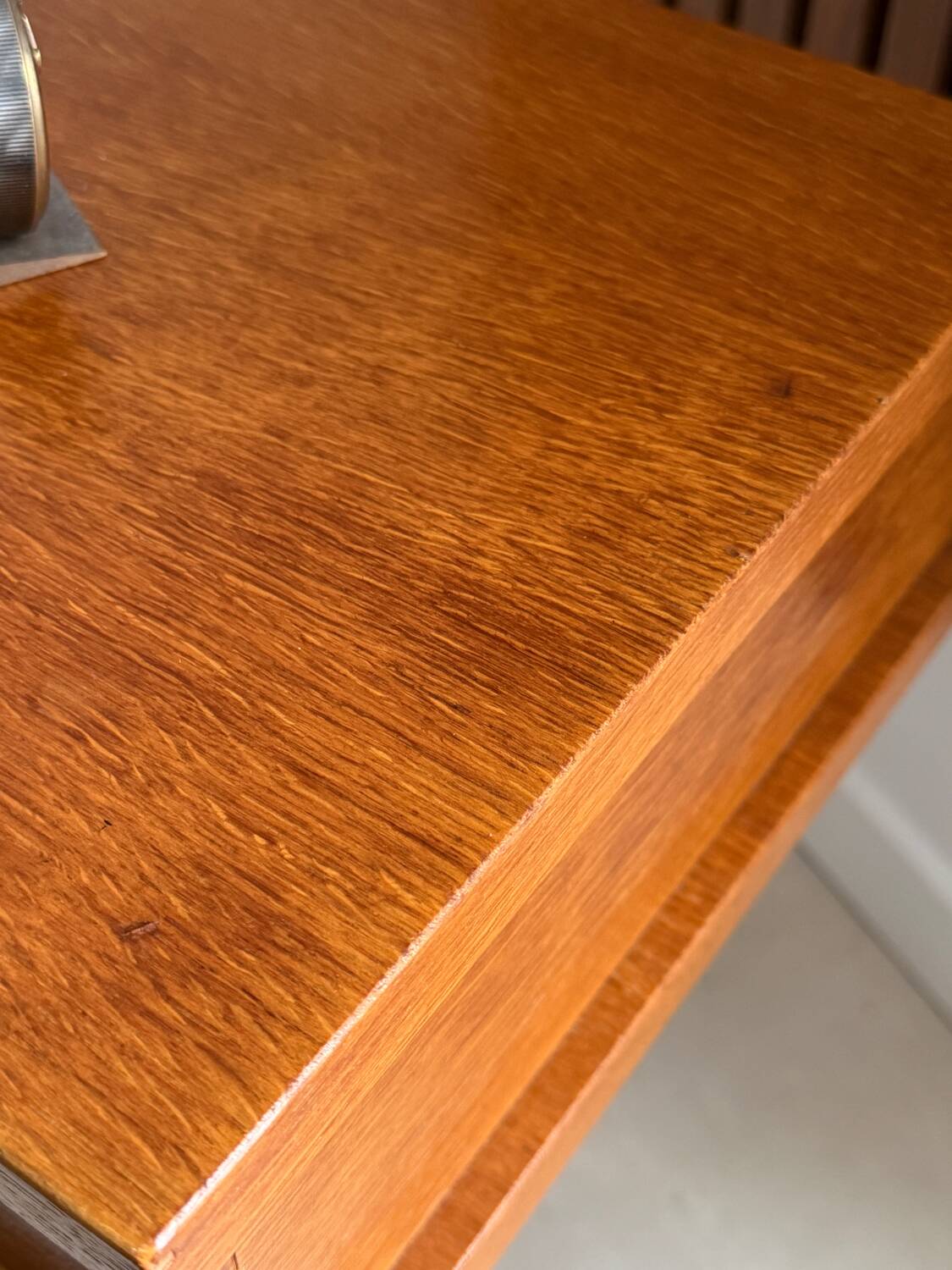 Vintage bedside table with tapered legs.