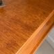 Vintage bedside table with tapered legs.