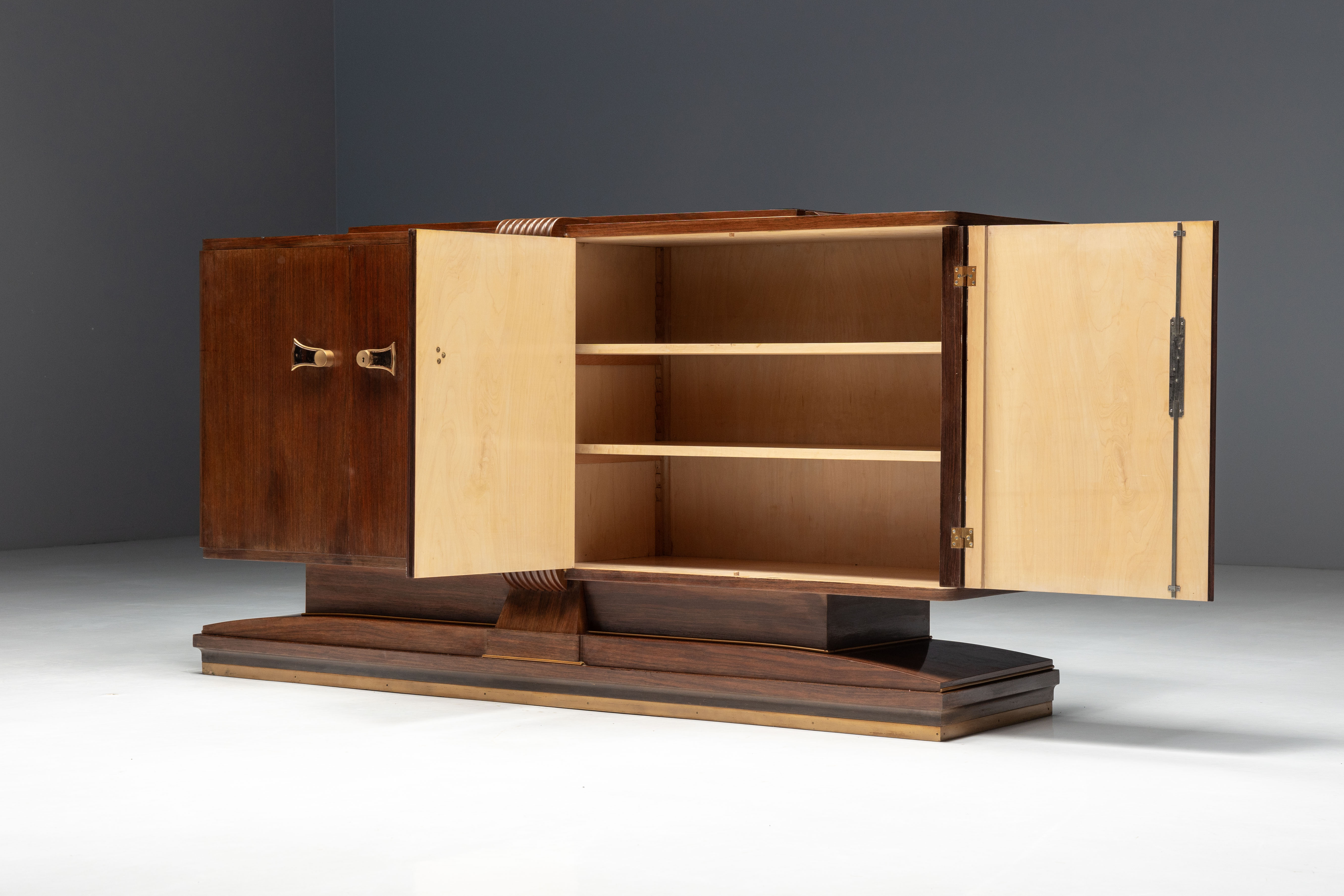 Art Deco walnut sideboard with brass details and sculptural base, France, 1930s