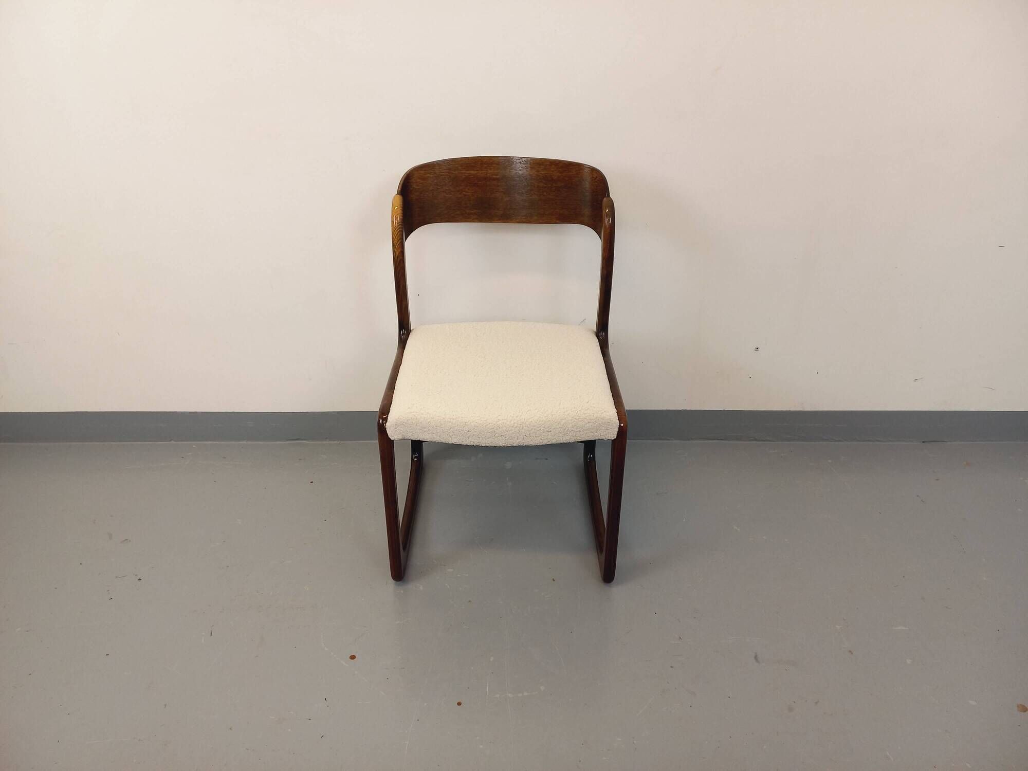Vintage sled chair by Baumann in wood and boucle fabric.