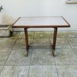 Old bistro table in wood and brass.