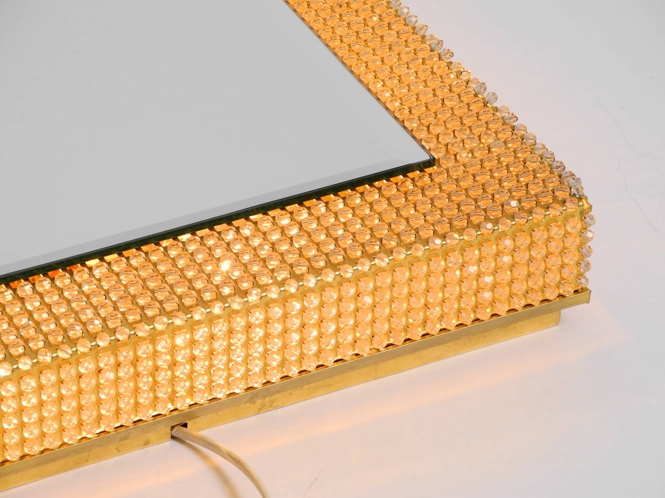 1960s brass wall backlit mirror, frame with glass beads by Palwa