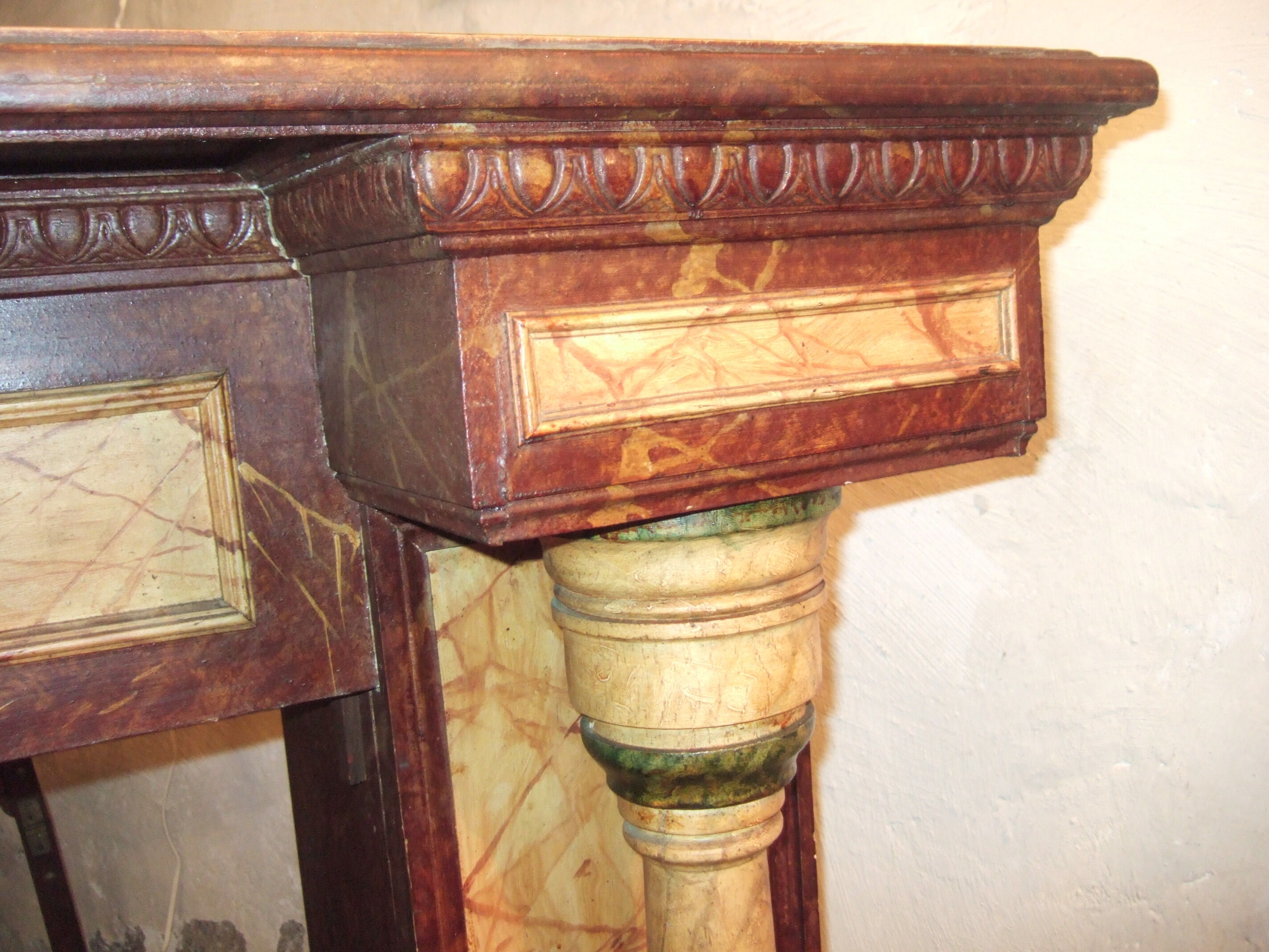19th century wooden fireplace, faux marble paint. Can act as a console.