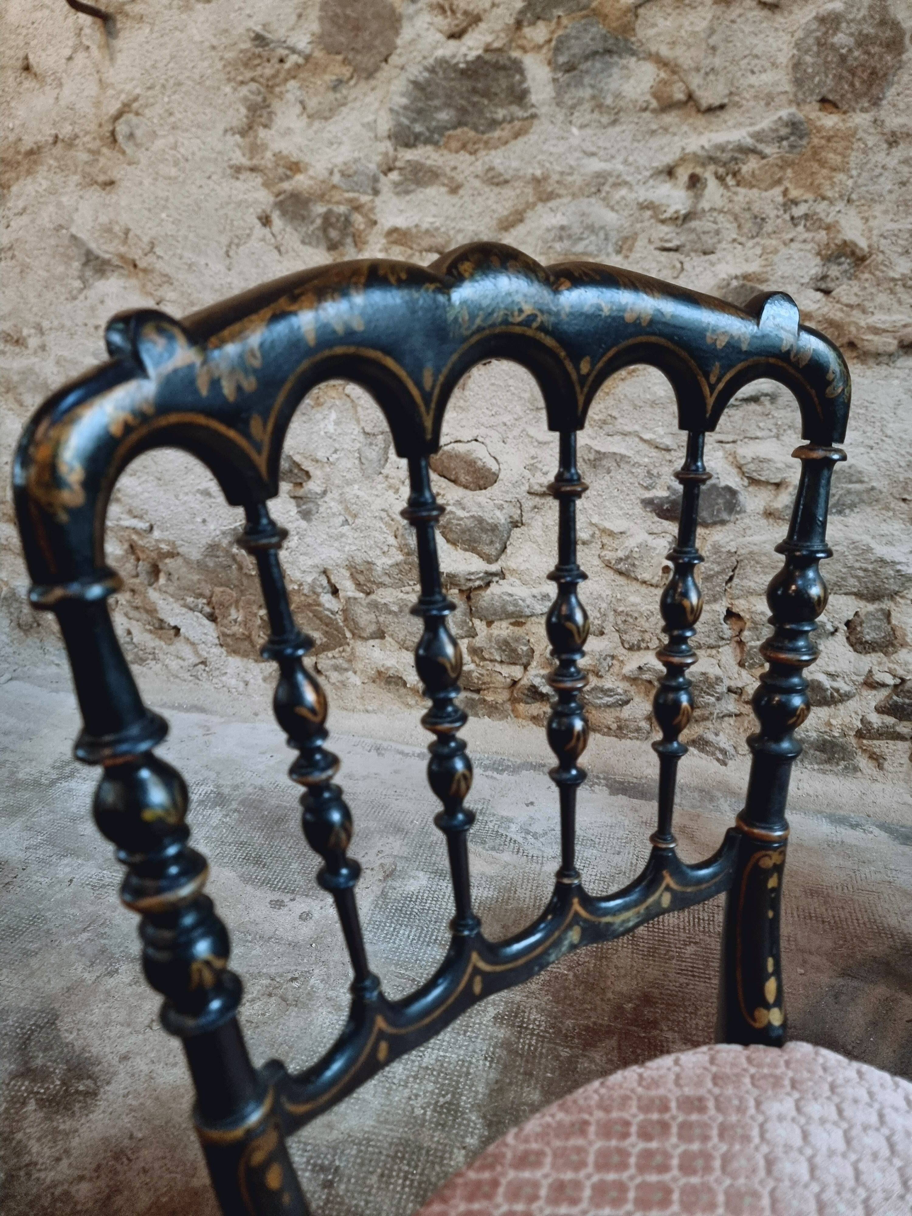 Pair of antique Napoleon III chairs in blackened wood and fabric.
